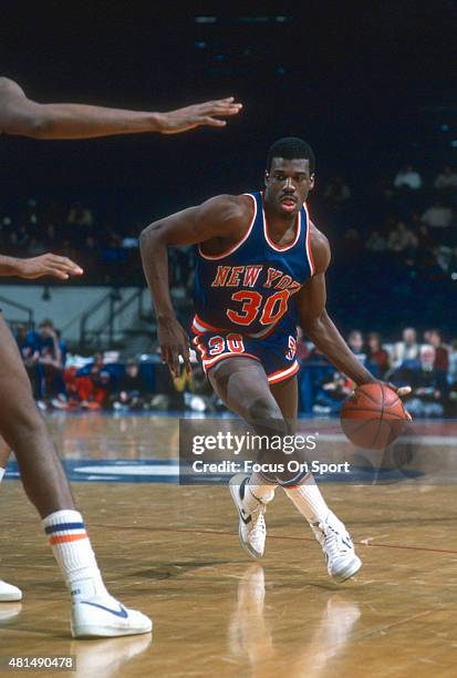 Bernard King of the New York Knicks dribbles against the Washington Bullets during an NBA basketball game circa 1984 at the Capital Centre in...