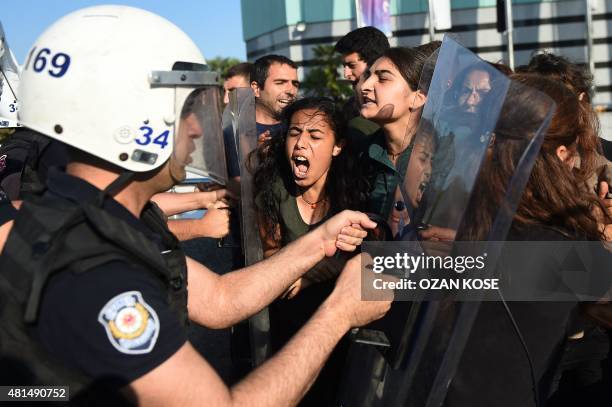 Turkish riot police clash with protesters as they attempt to detain them in Istanbul on July 21 a day after a suicide bomb attack the day before...