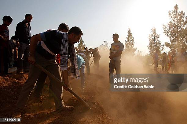 Mourners bury victims of Monday's bomb blast at a cemetery on July 21, 2015 in Suruc, Turkey. The bomb attack in the Turkish town of Suruc killed at...