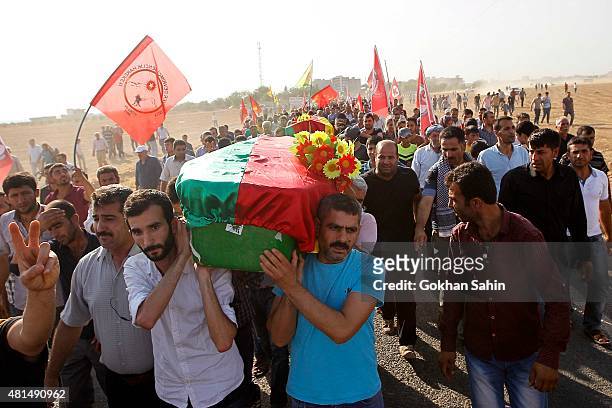 Relatives and friends carry the coffin of a victim who was killed in Monday's bomb blast during a funeral ceremony at a cemetery on July 21, 2015 in...