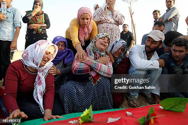 Relatives of a victim who was killed in Monday's bomb blast mourn during a funeral ceremony at a cemetery on July 21, 2015 in Suruc, Turkey. The bomb...