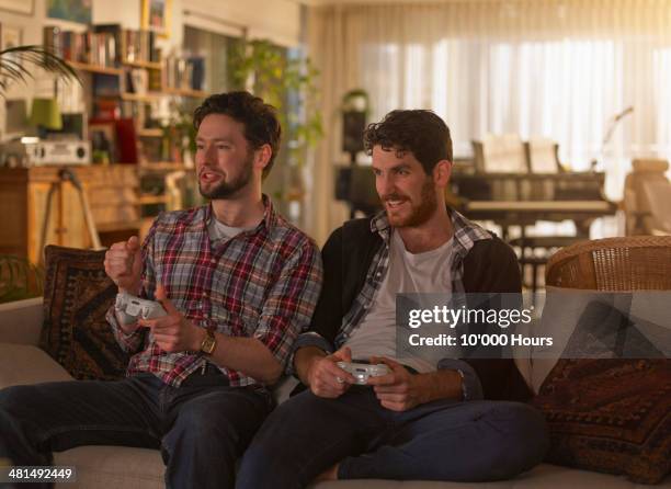 too young men playing video games - playing toy men stock pictures, royalty-free photos & images