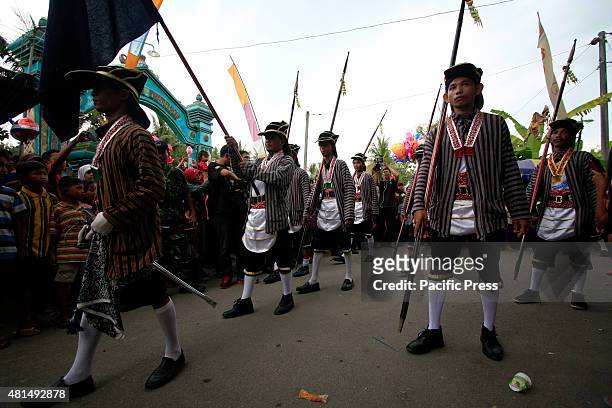 Residents dressed up in traditional Javanese costumes to follow the Nyadran ritual at the Sewu Cemetery. The Nyadran ritual is a tradition where the...