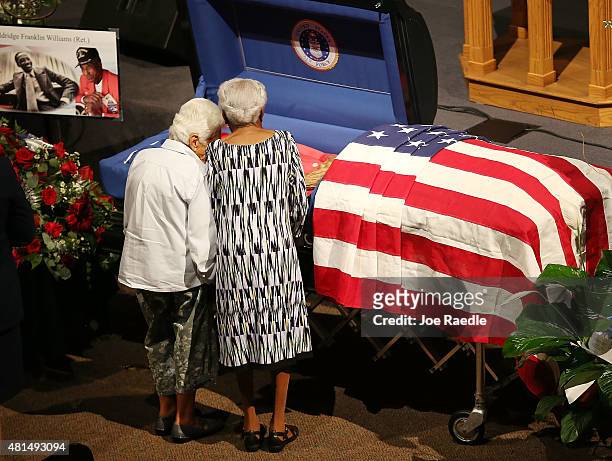 Taya Seligman and Lucille Wiggins pay their respects to Lucille's longtime neighbor Retired Air Force Lt. Col. Eldridge Williams at the Sweet Home...