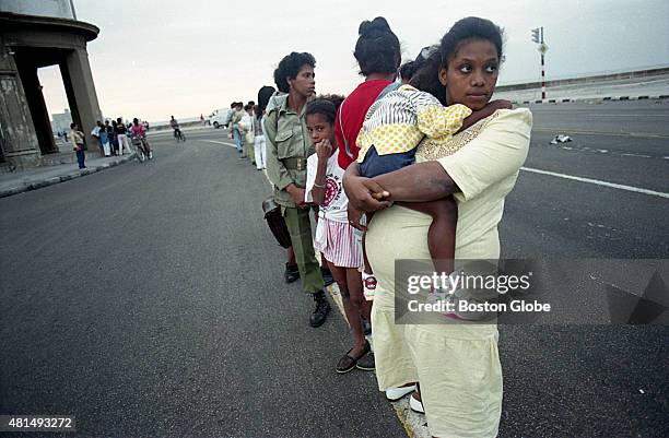 Luvia Diaz, eight months pregnant with her second child, lined up in the middle of the Malecón hoping to hitchhike back to her home. The Castro...