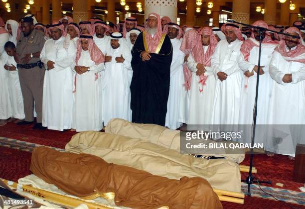 Saudi mufti Abdul Aziz al-Sheikh leads the prayers over three bodies of people killed yesterday in a car bomb explosion outside the general security...