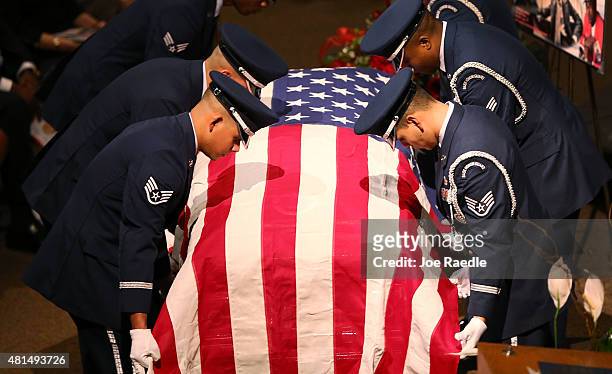 Members of the U.S. Air Force 482nd Fighter Wing Honor Guard prepare to fold the American flag to deliver to a family member during the funeral of...