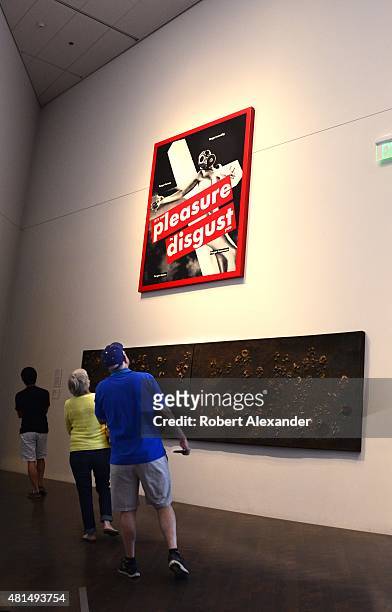 Visitors at the Denver Art Museum in Denver, Colorado, admire a silkscreen painting by Barbara Kruger titled 'Untitled '.