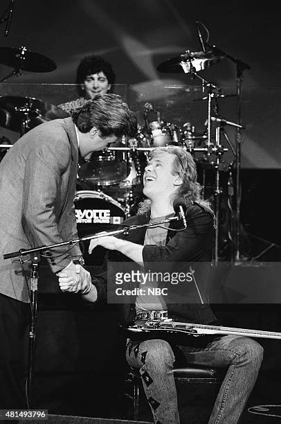 Pictured: Guest host Jay Leno and Jeff Healey of the musical guest The Jeff Healey Band on December 20, 1990 --