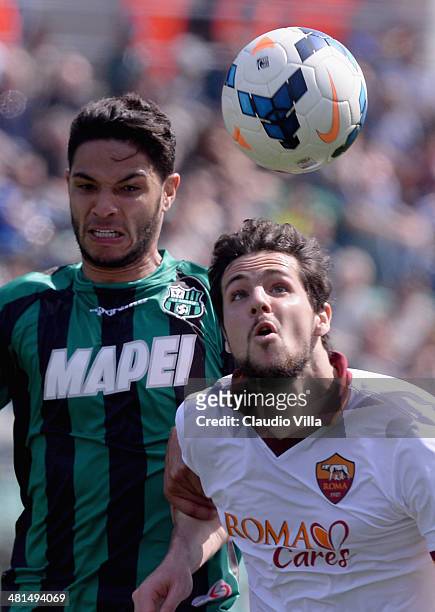 Mattia Destro of AS Roma and of Pedro Mendes of US Sassuolo Calcio compete for the ball during the Serie A match between US Sassuolo Calcio and AS...