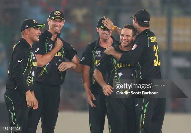 Brad Hodge of Australia is congratulated by his teammates after dismissing Rohit Sharma of India during the ICC World Twenty20 Bangladesh 2014 match...