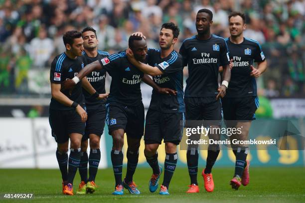 Jaques Zoua Daogari of Hamburger SV celebrates with team mates after scoring his team's first goal during the Bundesliga match between Borussia...