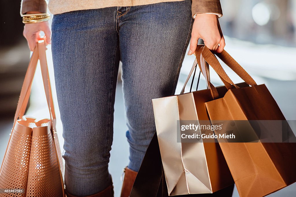 Woman carrying shopping bags.