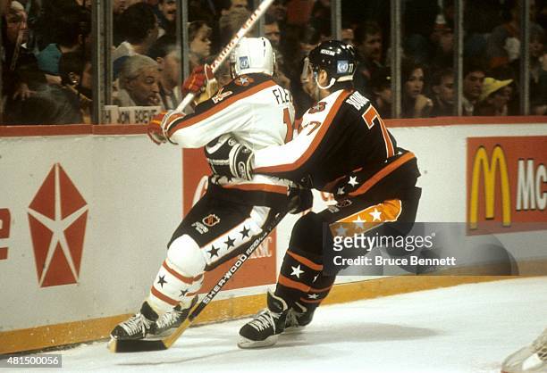 Ray Bourque of the Wales Conference and the Boston Bruins checks Theoren Fleury of the Campbell Conference and the Calgary Flames during the 1991...