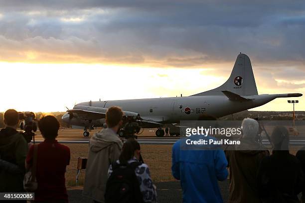 International media film a Republic of Korea P3 Orion after returning from a search mission for debris from Malaysia Airlines flight MH370 at RAAF...