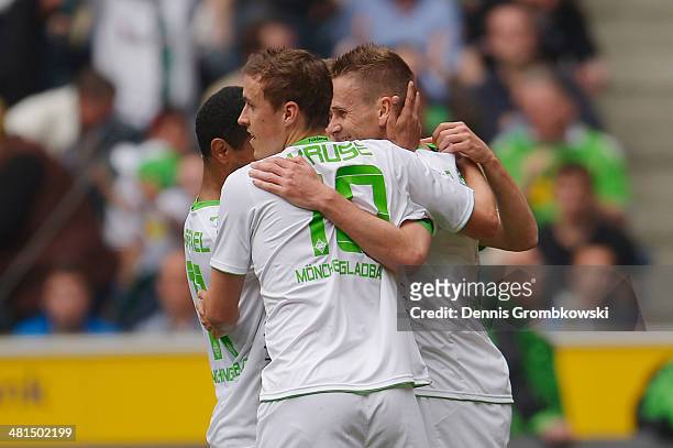 Filip Daems of Moenchengladbach celebrates with team mates after scoring his team's first goal during the Bundesliga match between Borussia...