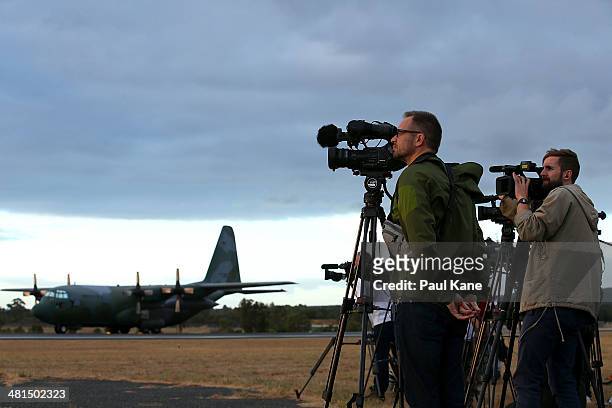 Republic of Korea C130 Hercules is seen as International media film a Republic of Korea P3 Orion after returning from a search mission for debris...