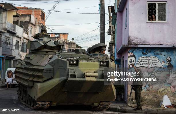 Brazilian marines on APCs patrol along the Nueva Holanda favela, part of the Favela da Mare shantytown complex in Rio de Janeiro, Brazil, on March...