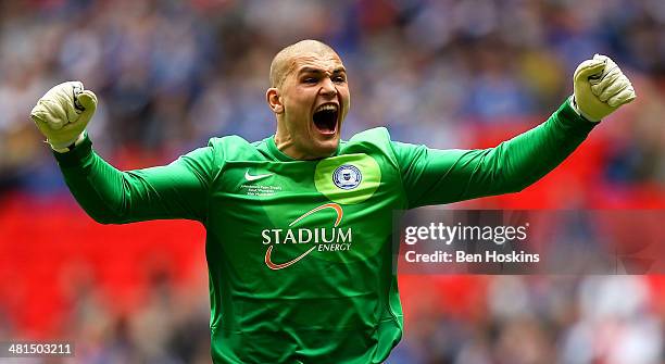 Bobby Olejnik of Peterborough celebrates after his team mate Josh Mcquoid scored the opening goal of the game during the Johnstone's Paint Trophy...