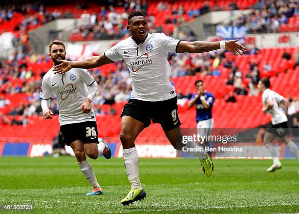 Britt Assombalonga of Peterborough celebrates after scoring his team's third goal of the game during the Johnstone's Paint Trophy Final between...