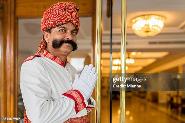 indian concierge welcome guest at hotel entrance india - new delhi gold stock pictures, royalty-free photos & images