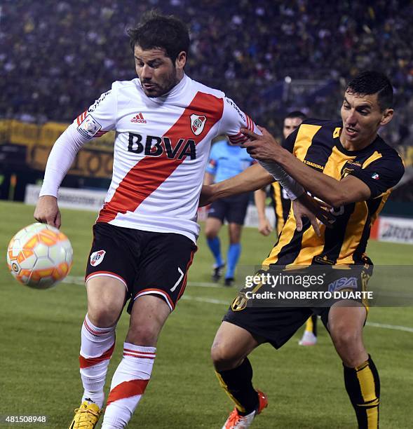 Argentina's River Plate Rodrigo Mora is marked by Julian Benitez of Paraguay's Guarani during the Libertadores Cup semi-final second leg football...