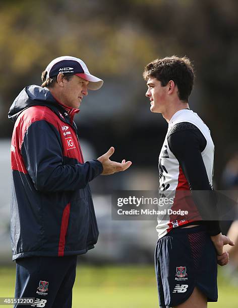 Demons head coach Paul Roos speaks to Angus Brayshaw of the Demons during a Melbourne Demons AFL training session at AAMI Park on July 22, 2015 in...