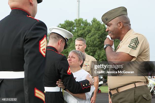 Cathy Wells, mother of Lance Cpl. Skip Wells, is presented flowers and hugged by Wells' best friend Lance Cpl. Kurt Bright during his memorial at...