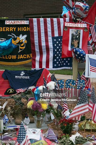 Flags, flowers and cards are left at a memorial site for Lance Cpl. Skip Wells at Sprayberry High School on July 21, 2015 in Marietta, Georgia. Wells...