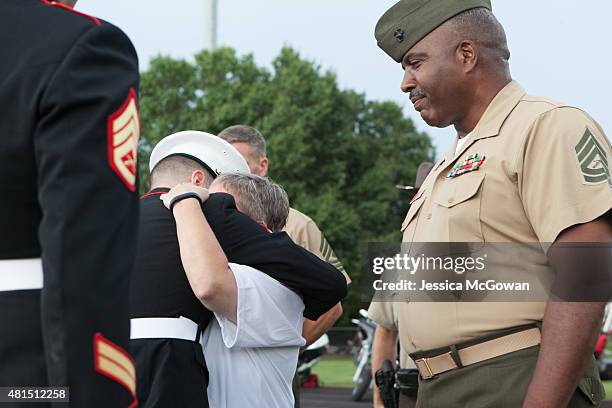 Cathy Wells, mother of Lance Cpl. Skip Wells, is presented flowers and hugged by Wells' best friend Lance Cpl. Kurt Bright during his memorial at...