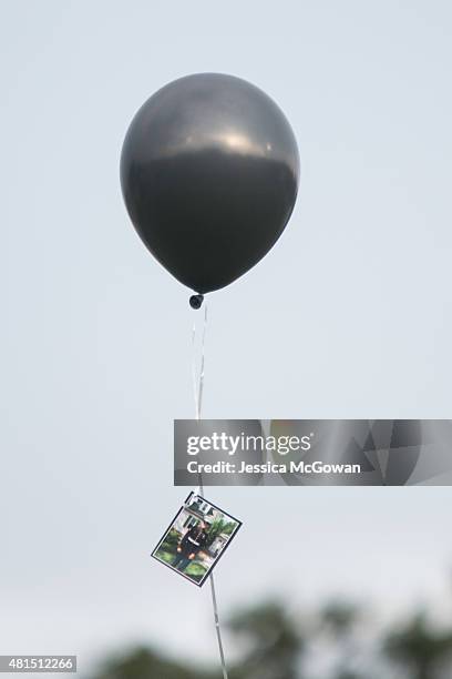 Friends and family release balloons with messages and photos of Lance Cpl. Skip Wells during his memorial at Sprayberry High School on July 21, 2015...