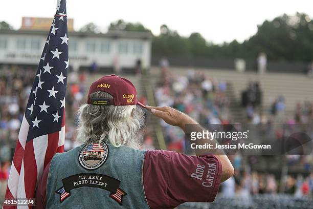 Jim Warren, with the Patriot Guard Riders, salutes during a memorial held for Marine Skip Wells at Sprayberry High School on July 21, 2015 in...
