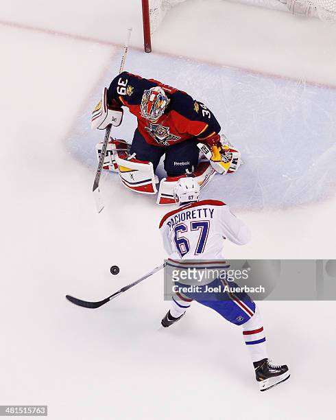 Goaltender Dan Ellis of the Florida Panthers stops a shot by Max Pacioretty of the Montreal Canadiens at the BB&T Center on March 29, 2014 in...
