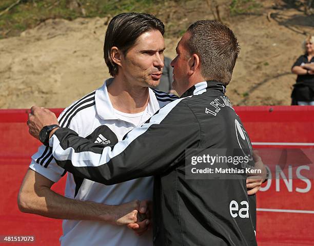 Head coach Thomas Brdaric of Neustrelitz talks with head coach Andreas Petersen of Magdeburg prior to the Regionalliga Nordost match between TSG...