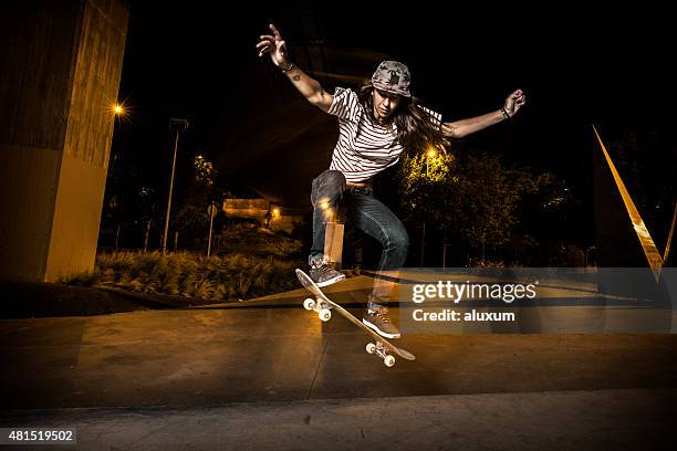 young girl skateboarder jumping - girl skateboard trick stock pictures, royalty-free photos & images