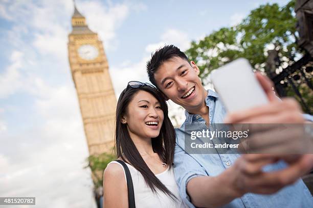 asian couple taking a selfie in london - big ben selfie stock pictures, royalty-free photos & images