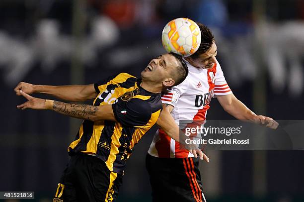 Matias Kranevitter of River Plate fights for the ball with Luis De La Cruz of Guarani during a second leg Semi Final match between Guarani and River...