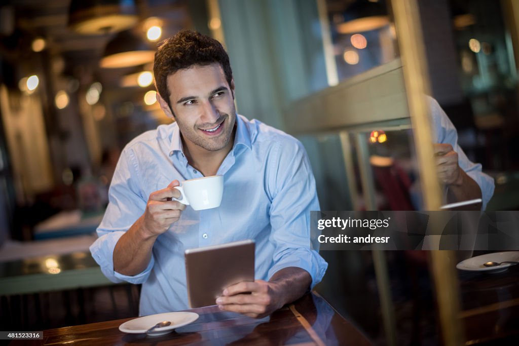 Man drinking coffee at a cafe