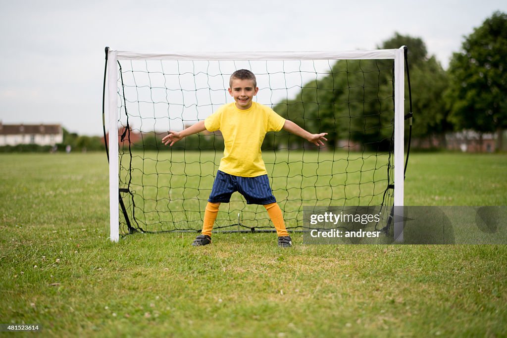 Boy playing soccer as a goalkeeper