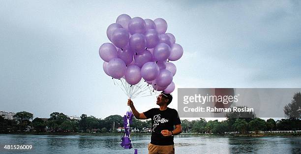 Volunteer from an NGO called Malaysians For Malaysia gets ready to release balloons as a symbol of remembrance for the victim of the ill-fated flight...