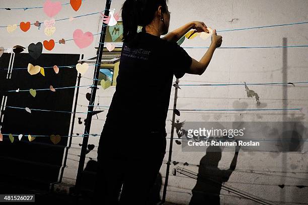 Volunteer prepares for an event to remember the victim of the ill-fated flight MH370 on March 30, 2014 in Kuala Lumpur, Malaysia. The Australian...