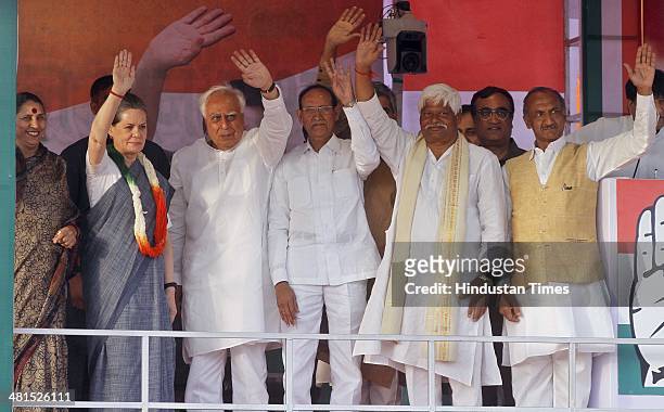 Chairperson Sonia Gandhi with Congress party leader Kapil Sibbal during an election campaign rally for Lok Sabha elections, on March 30, 2014 in New...
