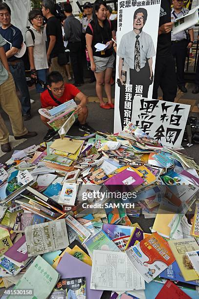 Pile of textbooks are seen in front of a placard of Taiwanese education minister Wu Se-hwa as Taiwanese high school students protest against the...