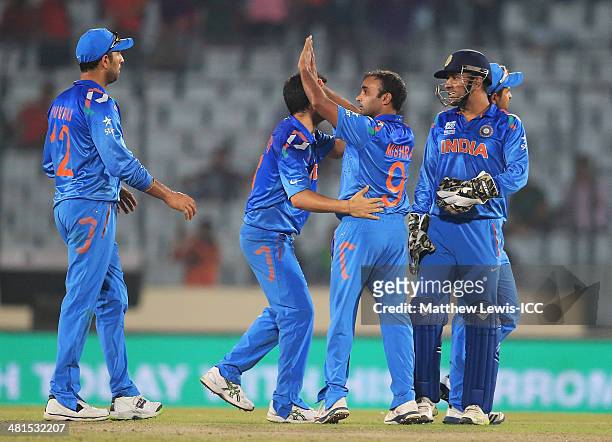 Amit Mishra of India is congratulated on the wicket of Brad Haddin of Australia, after he was caught by Ajinkya Rahane during the ICC World Twenty20...