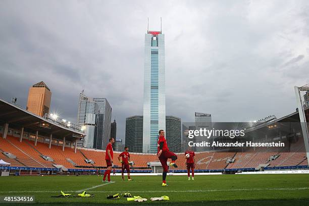 Manuel Neuer of FC Bayern Muenchen plays with his team mates Tom Starke , Sven Ulreich and Ivan Lucic during a training session at Tianhe Stadium on...