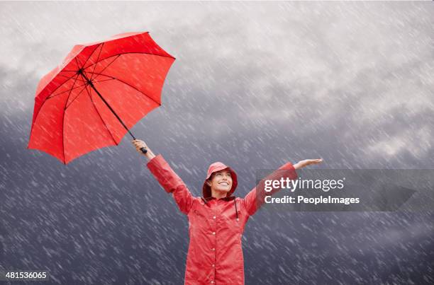 rain? who cares?! - female rain coat stock pictures, royalty-free photos & images