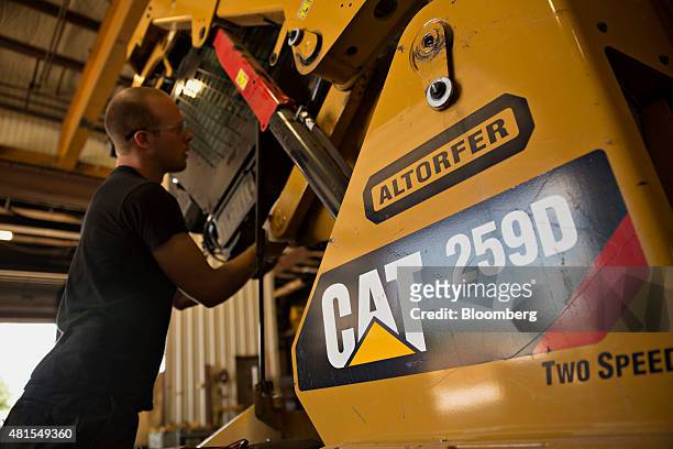 Technician works on a Caterpillar Inc. 259D compact track loader at the Altorfer Cat dealership in East Peoria, Illinois, U.S., on Tuesday, July 21,...