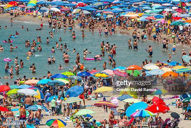 People sunbathe at Poniente Beach on July 22, 2015 in Benidorm, Spain. Spain has set a new record for visitors, with 29.2 million visitors in June,...