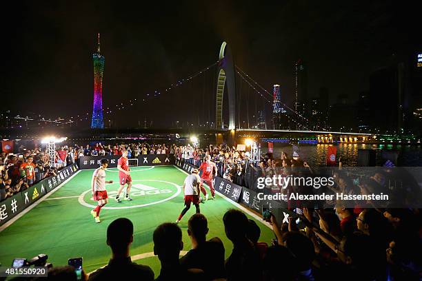 Thomas Mueller of FC Bayern Muenchen and his team mate Manuel Neuer plays a fun match at adidas marketing event on a cruise boat of the Guangzhou...