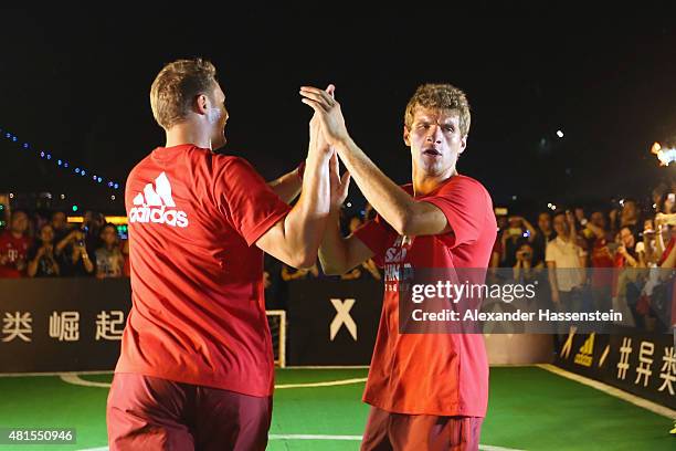 Thomas Mueller of FC Bayern Muenchen and his team mate Manuel Neuer plays a fun match at adidas marketing event on a cruise boat of the Guangzhou...